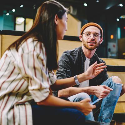 Decorative image - two people having a meeting in an open area