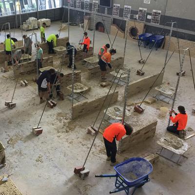 Decorative image - Clarkson campus bricklaying workshop with students working taken from above (NMTAFE)