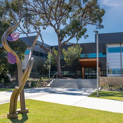 Joondalup Kendrew campus Automotive training building entrance with sculpture in foreground (NMTAFE)