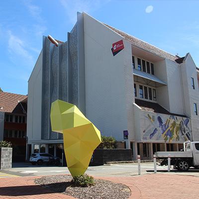 Leederville campus main building facade with sculpture in the foreground (NMATFE) 