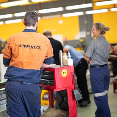 Decorative image - students in a workshop watching a lecturer demonstration (NMTAFE)