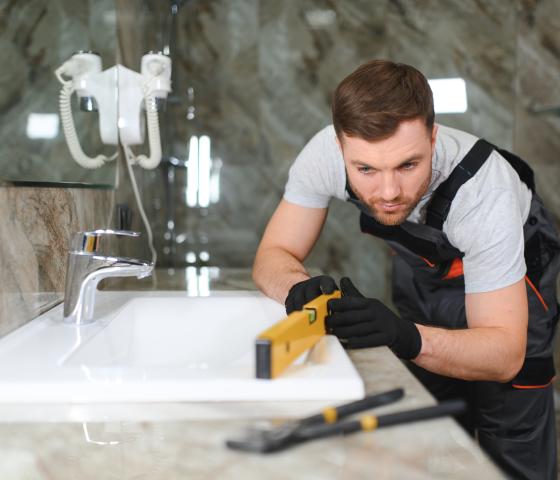 Decorative Image - Man installing bathroom sink