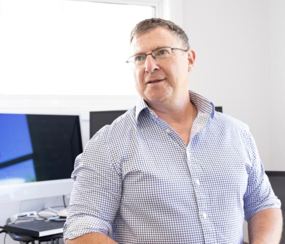 Man standing in front of computer screens