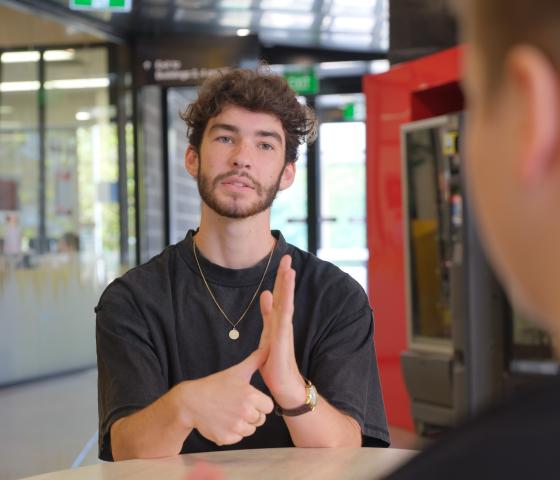 One male using Auslan signs