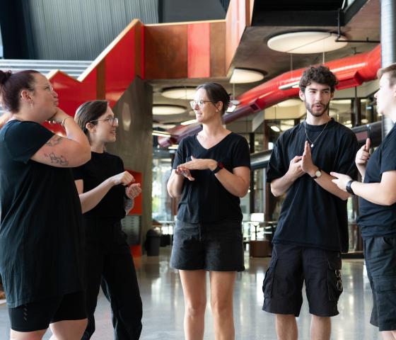Four people using Auslan