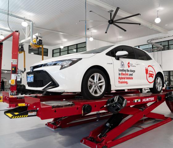 White hybrid car on a stand