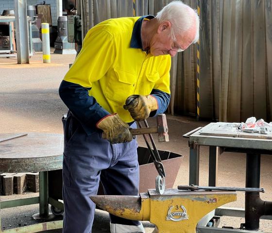 Decorative image - student using anvil