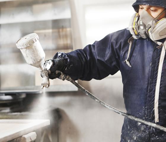 Spray Painter working in a booth painting furniture (iStock: IL21)