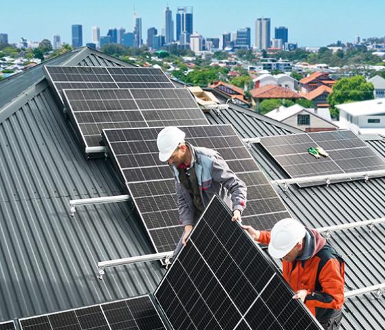 PV installers on the roof of a house installing a PV system