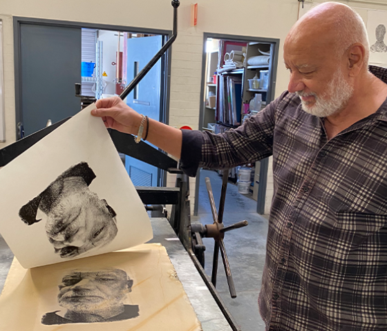 Man checking printed image of himself