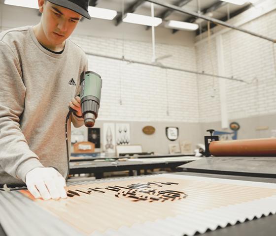 Decorative image - Student making a sign
