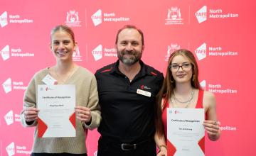 Two scholarship winners with their lecturer